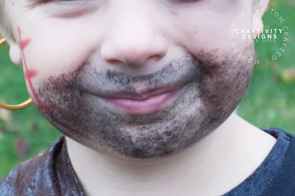 Close up image of child's chin with makeup applied to look like a beard.