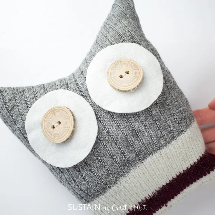 Sewn on felt cirlces and buttons on the sock owl.