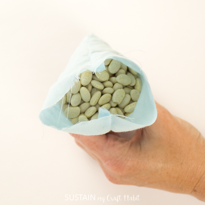 Showing the dried beans inside the scrap fabric pouch.