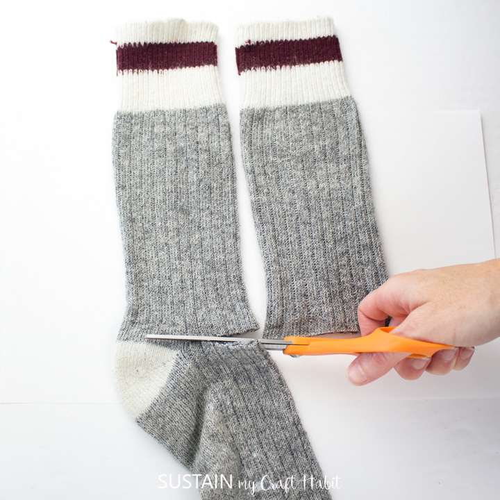 Cutting the feet off the wool tube socks. 