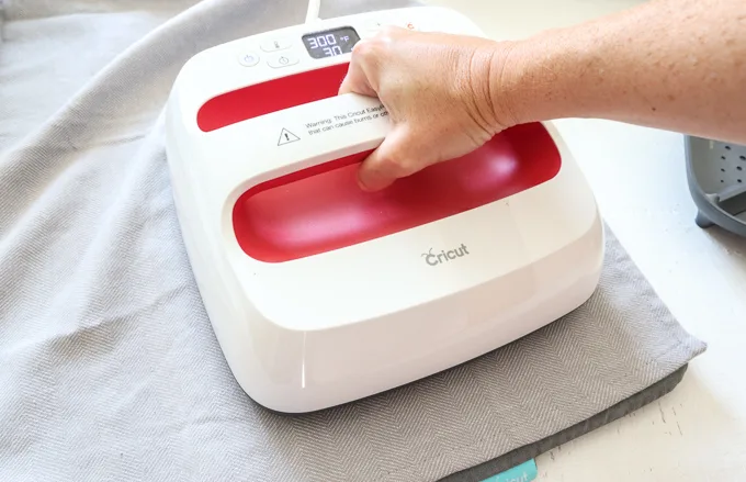 Preheating the tea towel with an EasyPress 2 machine.