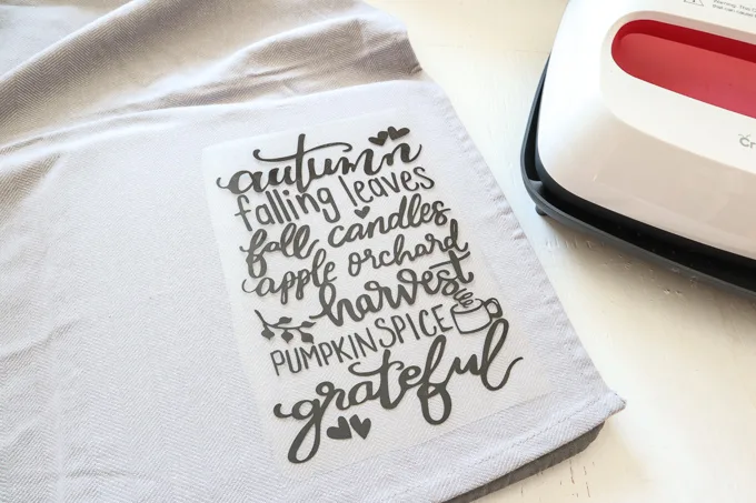 Placing the cut lettering onto the preheated tea towel.