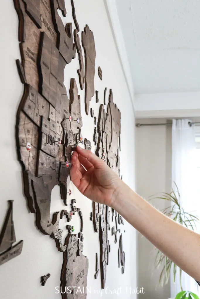 Using the country push pins to mark your travels on Enjoy the Wood's 3D world map wood wall art