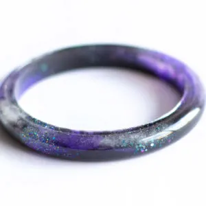close up image of a galaxy inspired resin bracelet