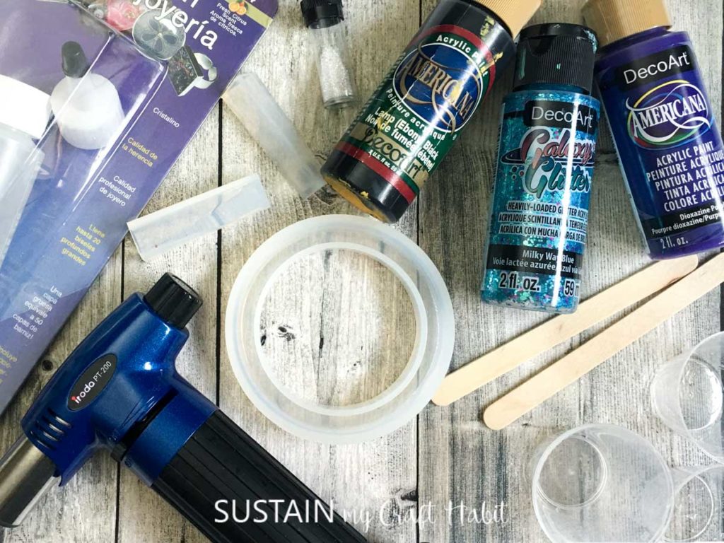 Materials needed to make a galaxy inspired resin bracelet.