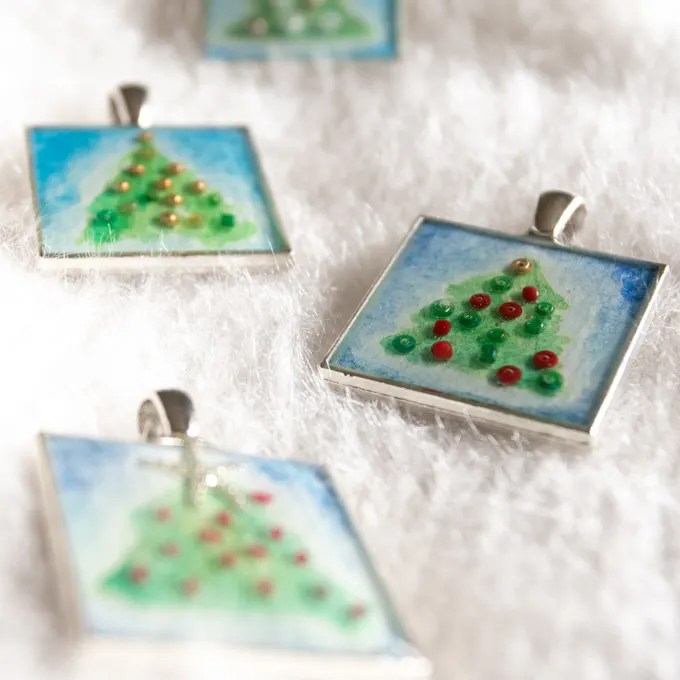 Close up of the finished Christmas tree resin pendants.