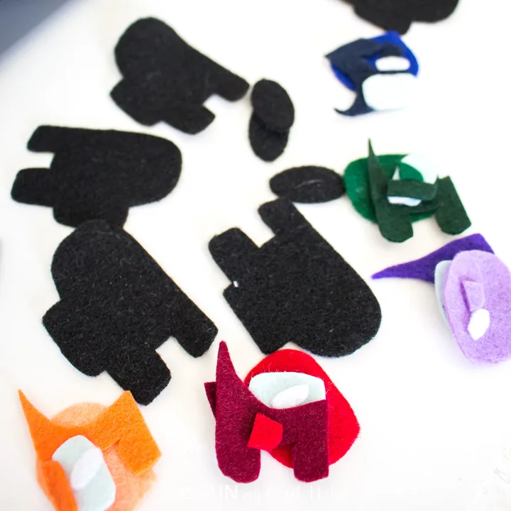 All of the felt pieces cut out for making Among Us pencil toppers.