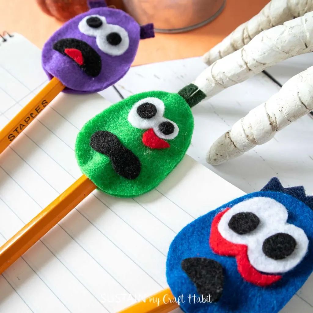 completed green, blue and purple felt DIY monster pencil toppers