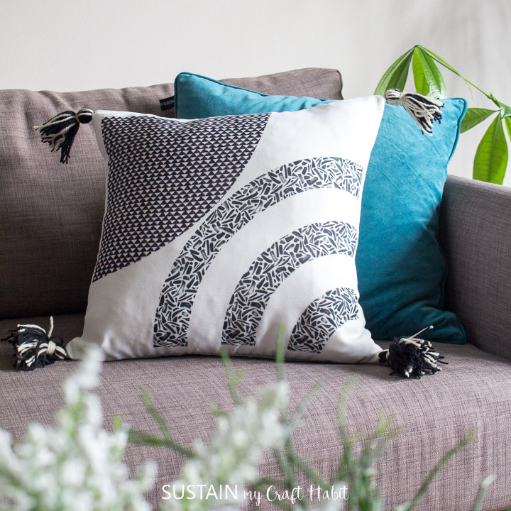 Throw pillows with tassels places on a couch.