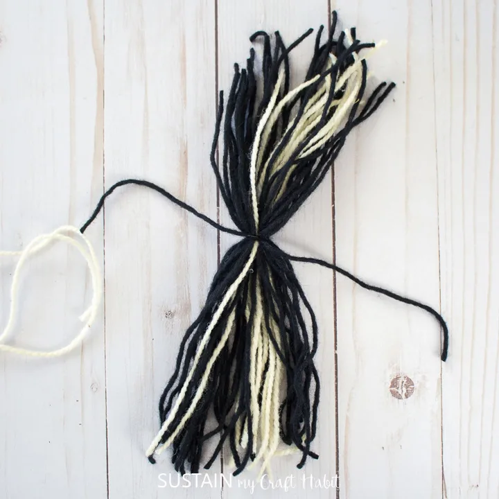 tying the strand of yarn around the mixed yarn. 
