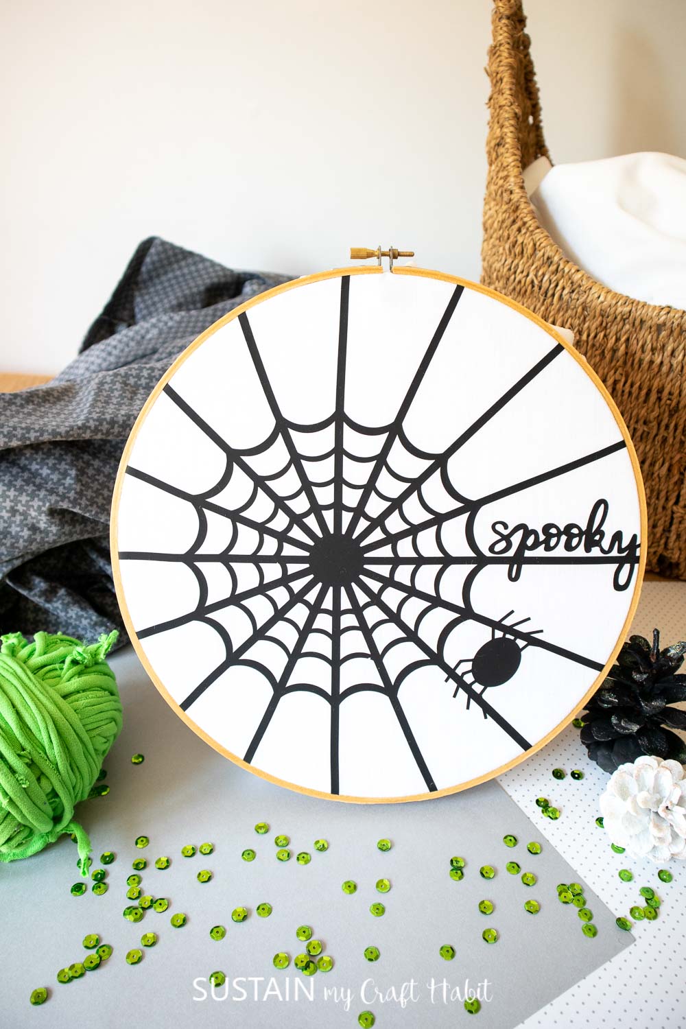 completed spider web art styled with green adn black accessories
