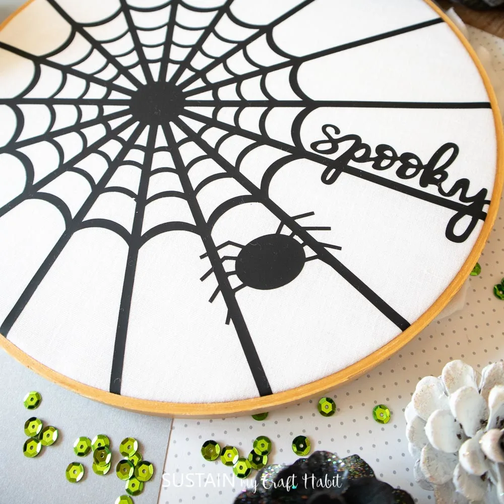 completed spider web art inside an embroidery hoop