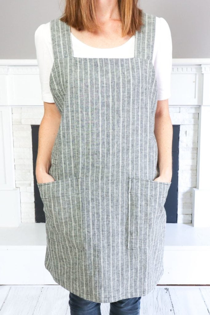 Wearing a striped square neck apron.