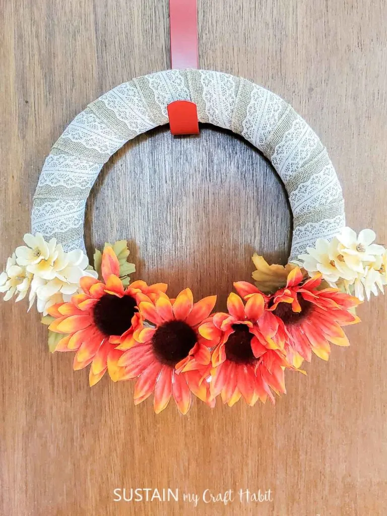 Dollar store fall wreath hung on a door.