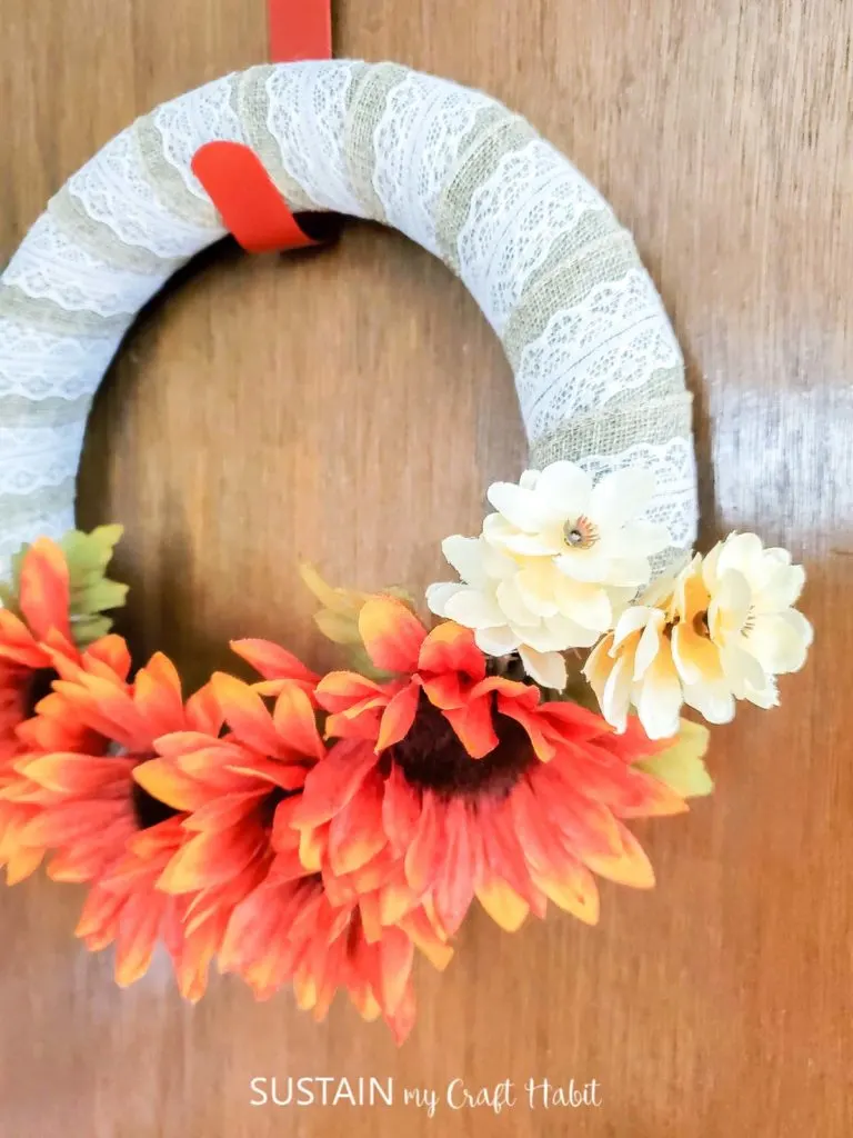 Dollar store fall wreath hung on a door.