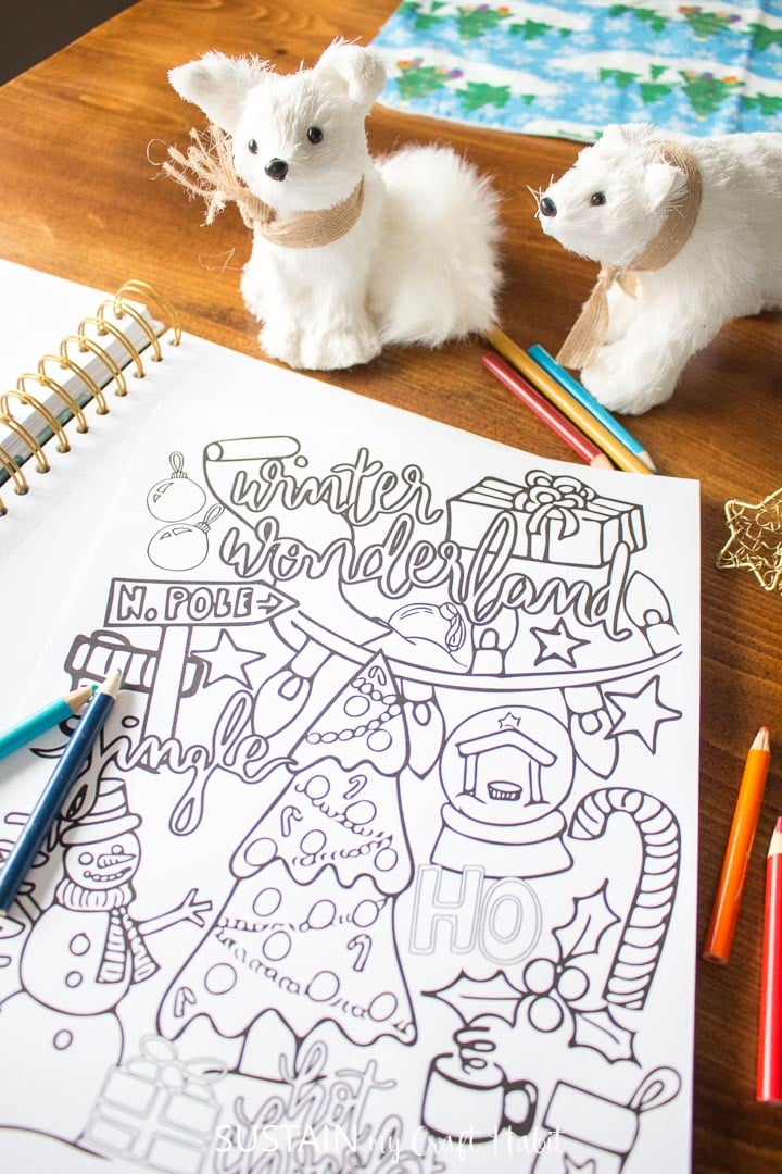 Winter coloring page with pencil crayons and toys.