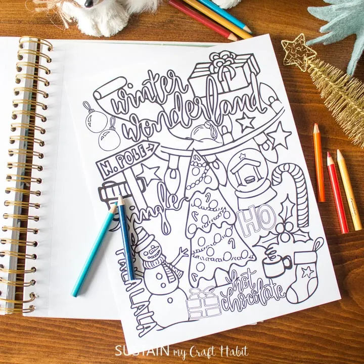 Winter coloring page on a notebook.