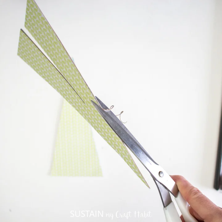 Trimming excess paper with scissors.