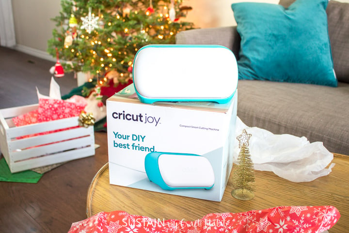 Cricut Joy stacked on top of a  box in front of a Christmas tree, opened  for Christmas