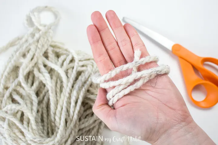Wrapping yarn around the palm of a hand.