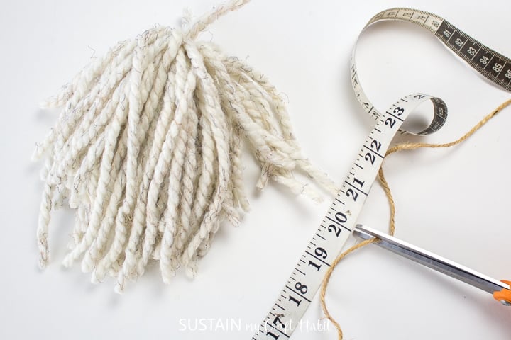 Measuring and cutting a piece of twine.