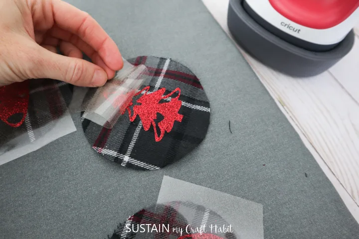 Peeling away the plastic from the vinyl image on the flannel fabric.