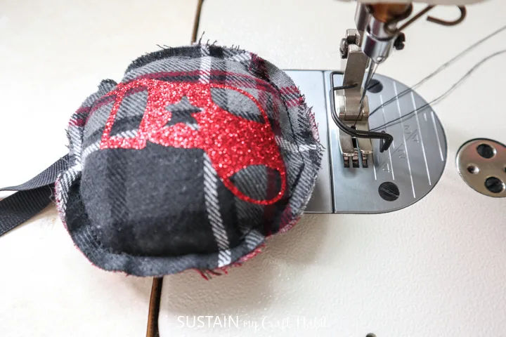 Sewing the flannel ornament shut.
