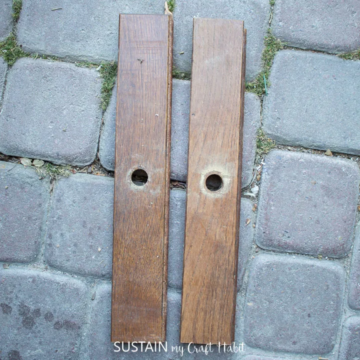 Two wood boards with holes in the middle.