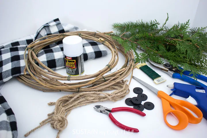 Materials needed to make a snowman wreath.