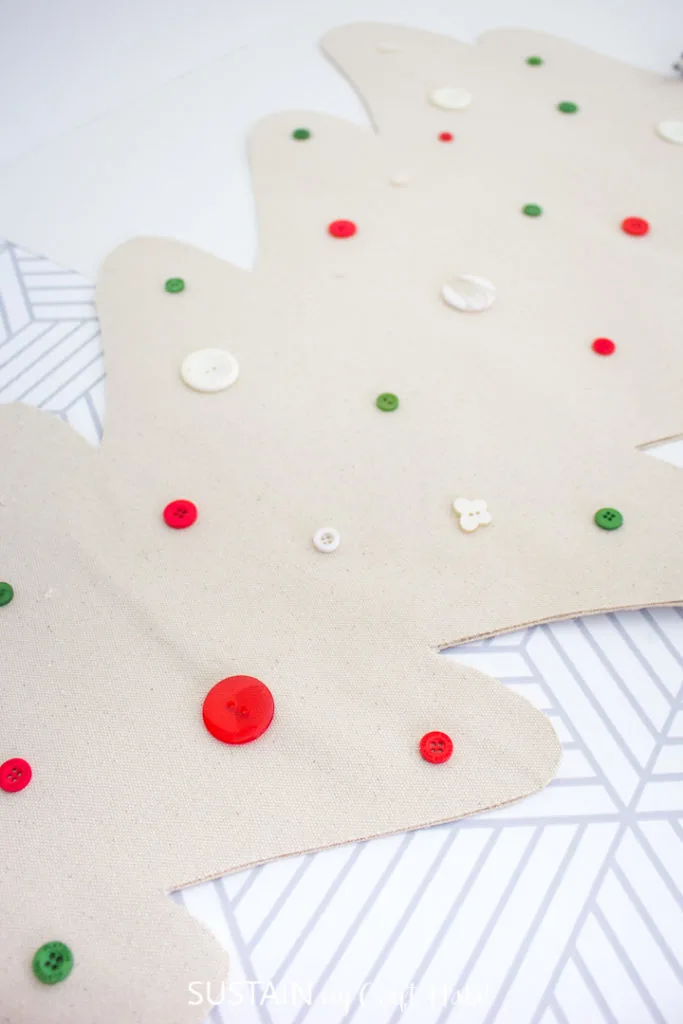 Adding colorful buttons onto the canvas Christmas tree.
