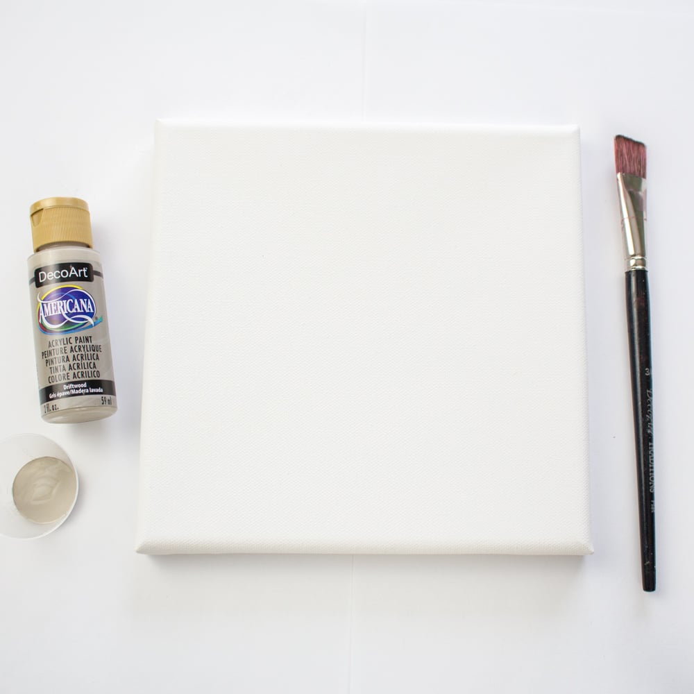 Materials needed to make canvas stencil art including a canvas, stencil, paint brushes and paint.