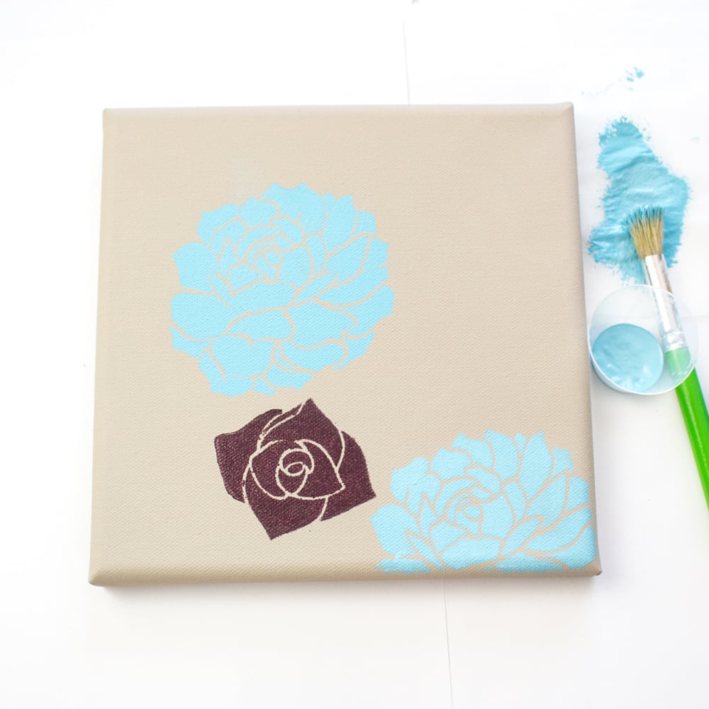 Canvas stencil art with flowers.