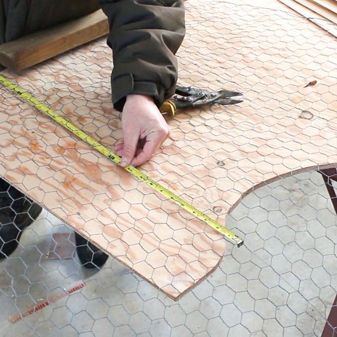Measuring the length of the chicken wire.