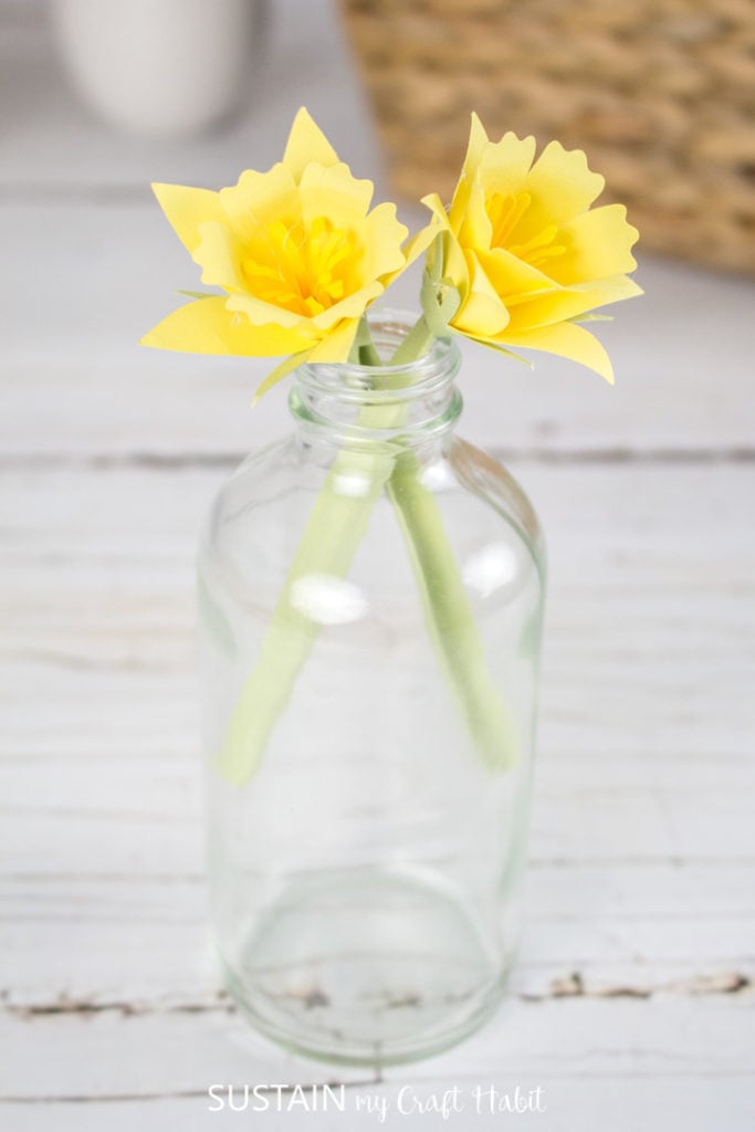 Paper daffodil flowers in a glass jar.