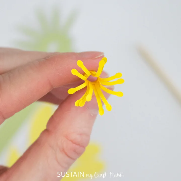 Curling the outer edge of the pistol paper flower. 