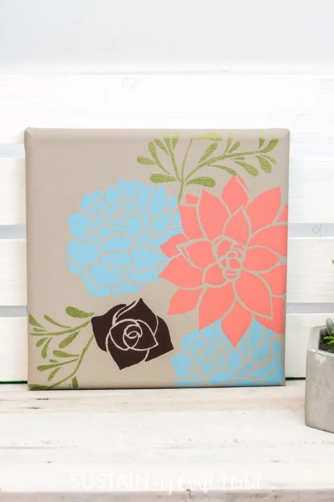 Canvas stencil art with flowers.