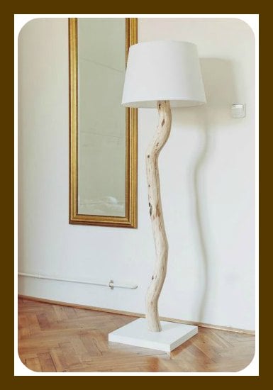 Large piece of beach wood as the stem of a lamp with a white shade.