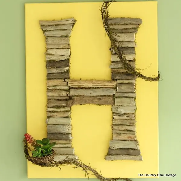 Monogram wall art made with small pieces of driftwood.