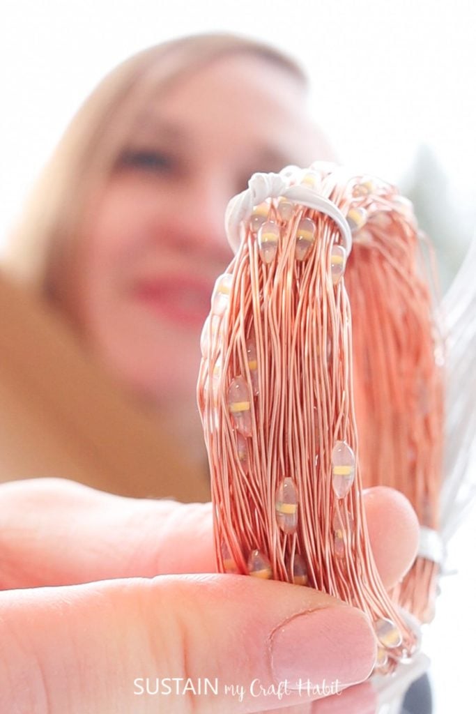 close up of copper strings used to solar power the lights