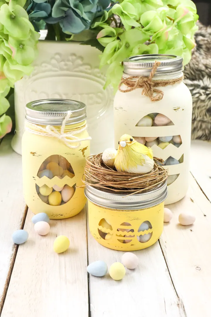 Easter candy jars made from mason jars and decorative twine and birds nest.