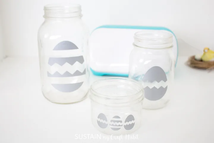 Vinyl Easter egg cut outs placed onto mason jars.