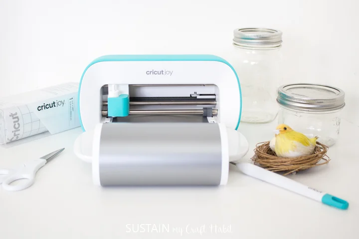 Loading the Cricut Joy machine with silver vinyl.