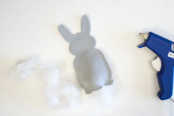 Filling the felt bunny with batting.