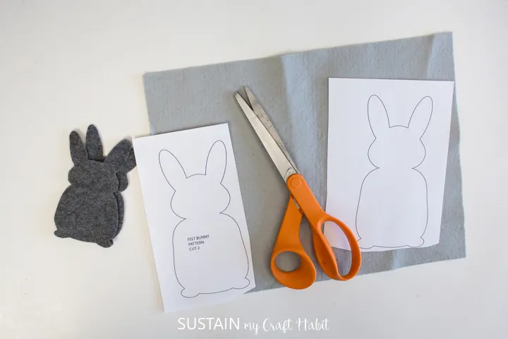 Setting the bunny templates on felt fabric with scissors.
