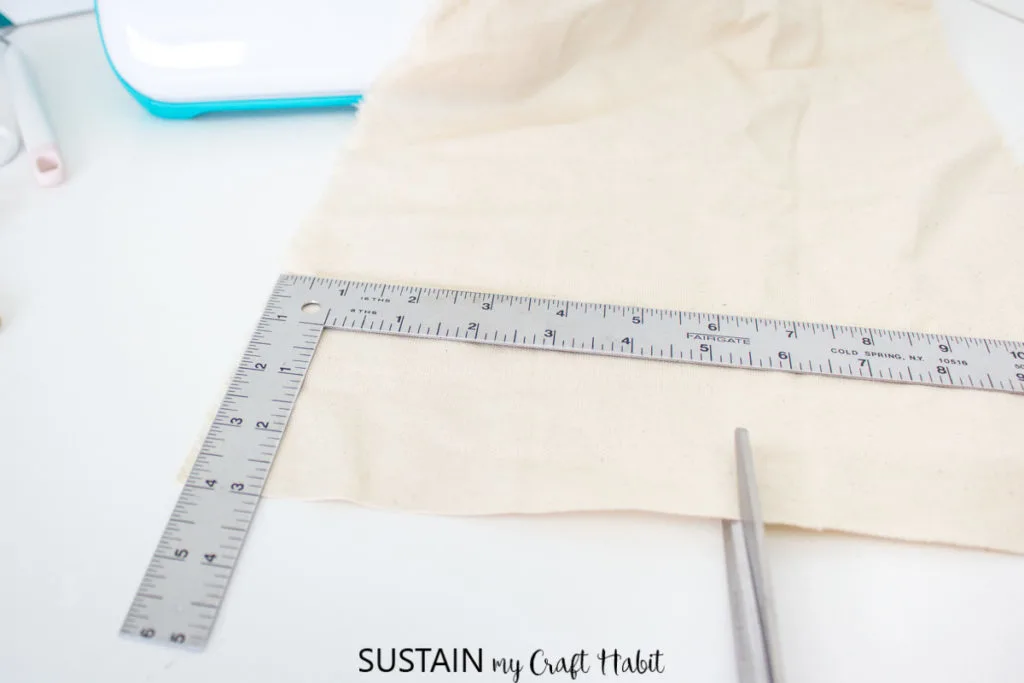 Cutting a piece of cotton fabric with scissors.