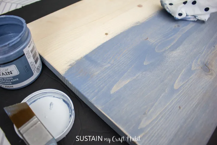 Painting the surface of a piece of pine wood. 