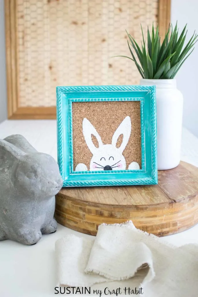 Painted Easter bunny in a blue frame.