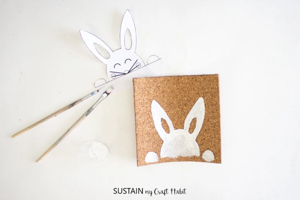 Painting the cork sheet to make a bunny.