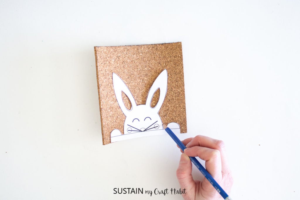 Tracing the bunny template onto the cork sheet.