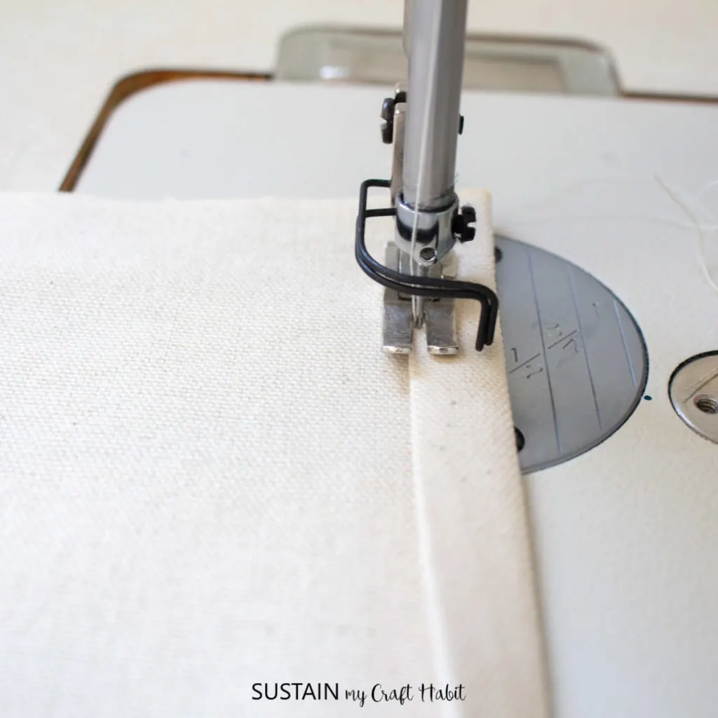 Sewing a hem onto the canvas.